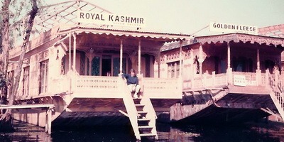 Woman sits on steps of houseboat on Dal lake, Srinagar, 1987